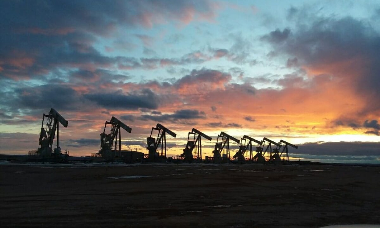 Oilfield pumpjacks at sunset in western North Dakota